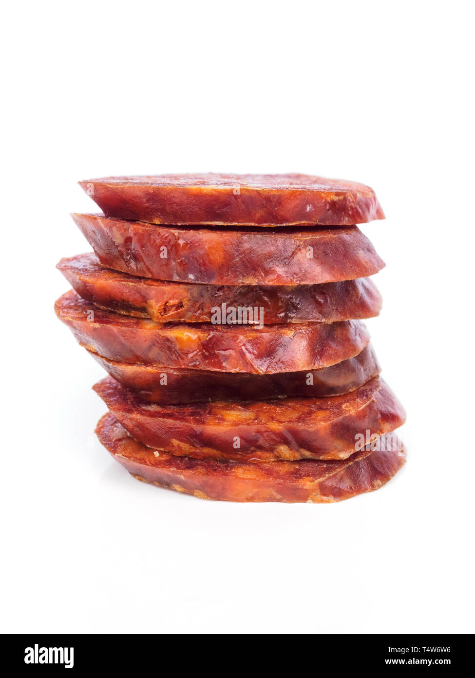 Chorizo ibérique, ​​Or la saucisse chorizo espagnol espagnol couper en rondelles placées l'une sur l'autre sur un fond blanc, typique espagnol tapa Banque D'Images