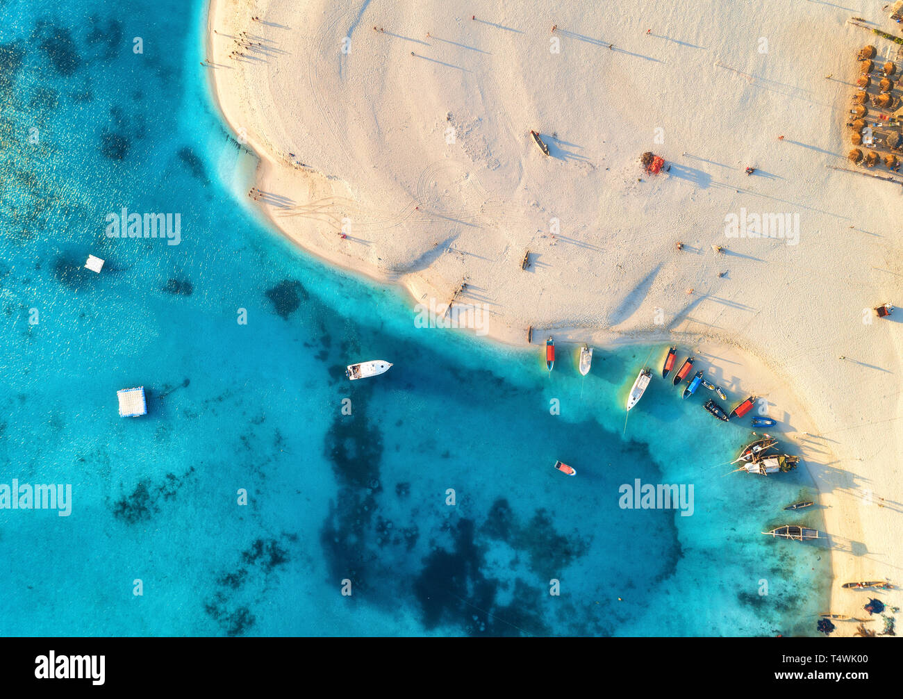 Vue aérienne de l'bateaux de pêche sur la côte de la mer tropical avec plage de sable fin au coucher du soleil. Village de pêcheurs sur l'Océan Indien, Zanzibar, Afrique. Landsca colorés Banque D'Images