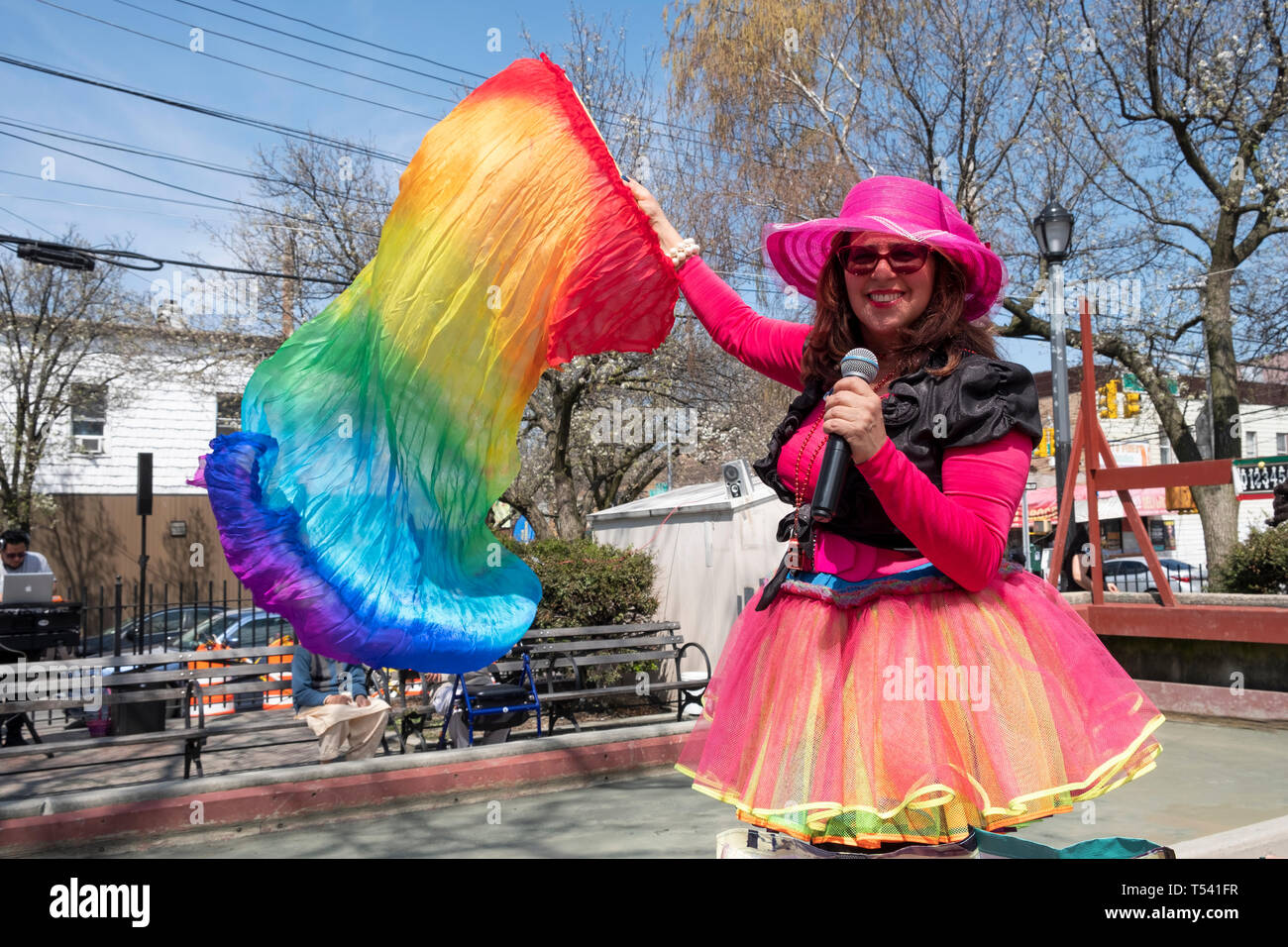 Une femme hispanique dans un costume coloré MCing une fête de Pâques dans un parc à Corona, Queens, New York. Banque D'Images