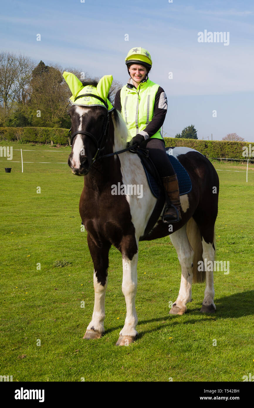Un cheval avec cavalier Vêtements haute visibilité se préparer à aller sur un hack dans la campagne anglaise. Banque D'Images