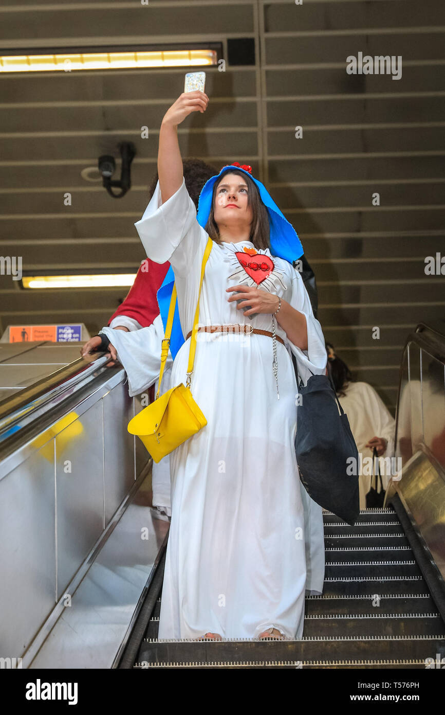 Londres, Royaume-Uni, 21 avril 2019. Marie prend un sur le tube en selfies la Station London Bridge. Les participants habillés comme Jésus, Marie et d'autres données connexes et biblique, avec un crucifix de prendre part à cette marche annuelle de Pâques alternative pub sur un itinéraire de bibliquement nommée pubs, de recueillir des fonds pour une cause caritative. Credit : Imageplotter/Alamy Live News Banque D'Images