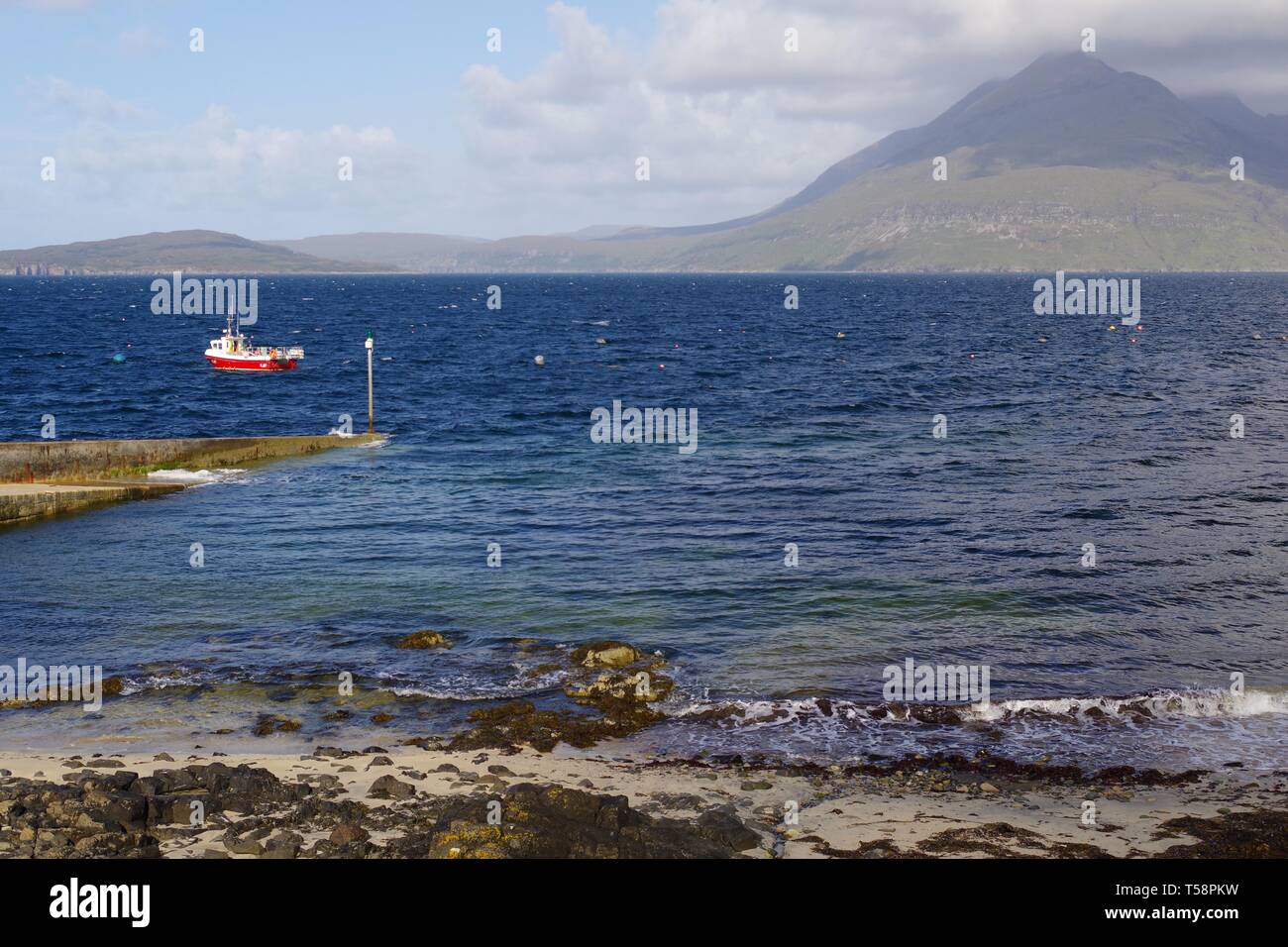 Petit bateau de pêche rouge à Elgol, vue sur le Loch Scavaig à l'Cullin Hills au-delà. Isle of Skye, Scotland, UK. Banque D'Images