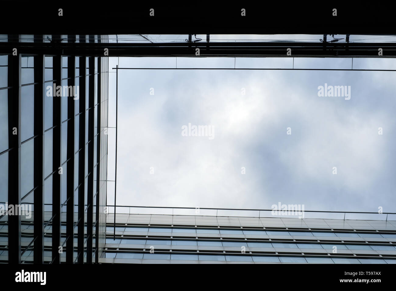 Low angle shot encadrée de contraste d'un immeuble moderne en tête contre le ciel Banque D'Images