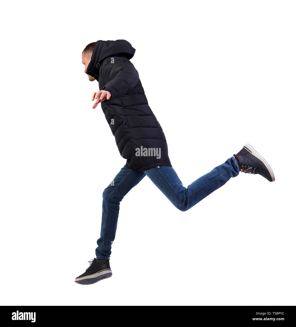 Vue latérale d'un homme dans une veste d'hiver qui saute. dos vue de personne. Vue arrière personnes collection. Plus isolé sur fond blanc. Le gars dans le Banque D'Images