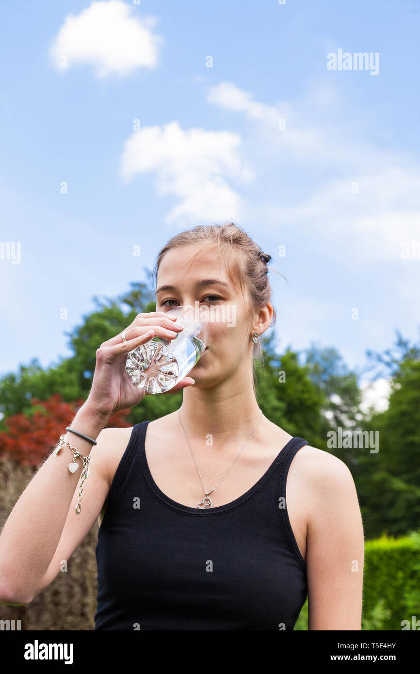Adolescente de boire un verre d'eau Banque D'Images