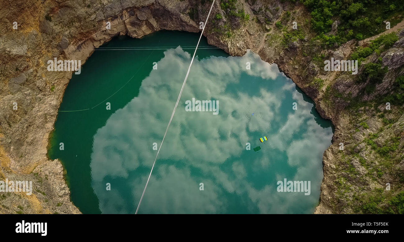 IMOTSKI, CROATIE - Mai 02 : un homme avec un saut en parachute au-dessus du lac rouge, Split-dalmatie, Imotski, la Croatie le 02 mai 2018 à Imotski, Croatie. Banque D'Images