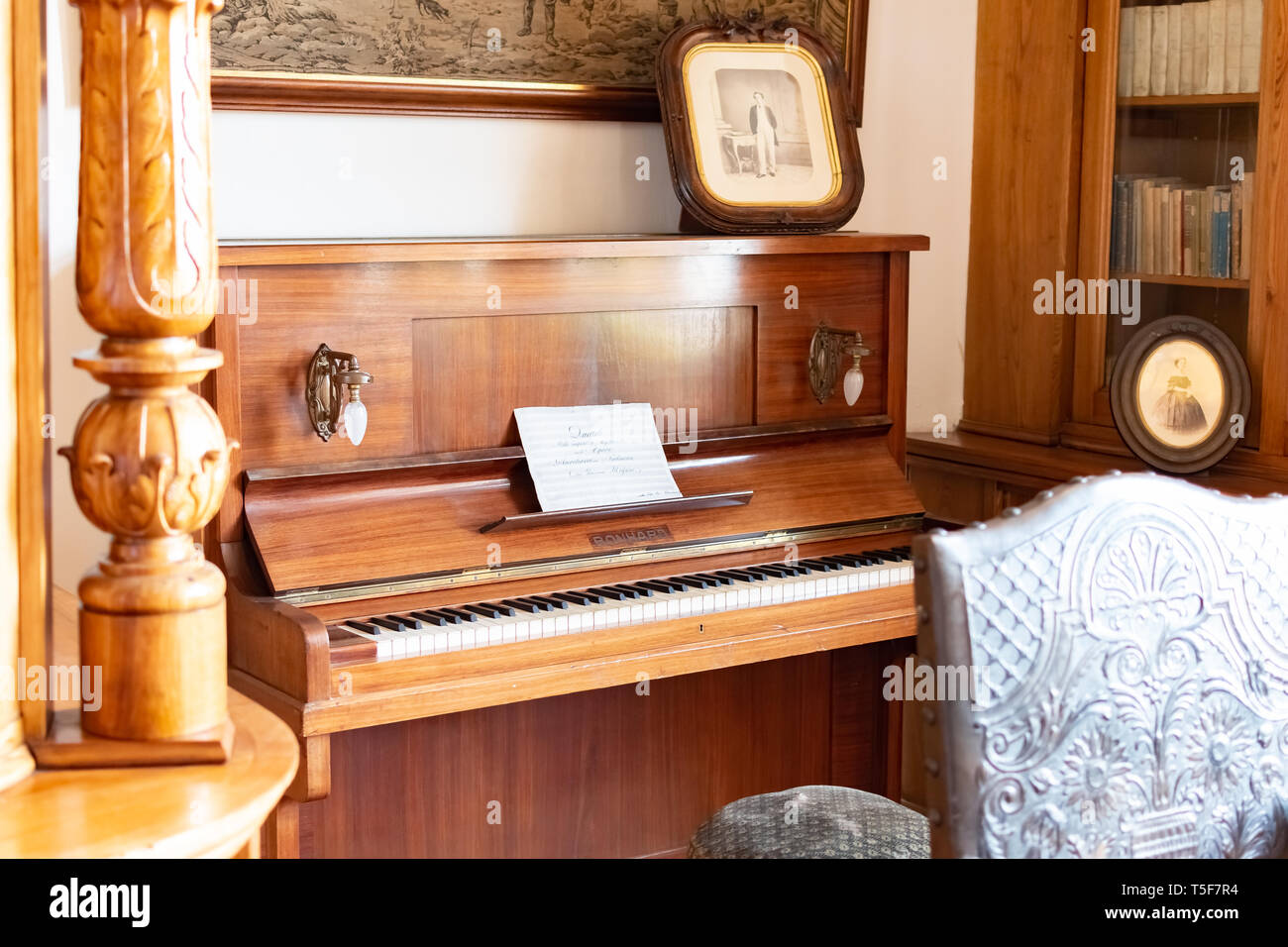 Vieux piano piano en bois dans la salle de style château Banque D'Images