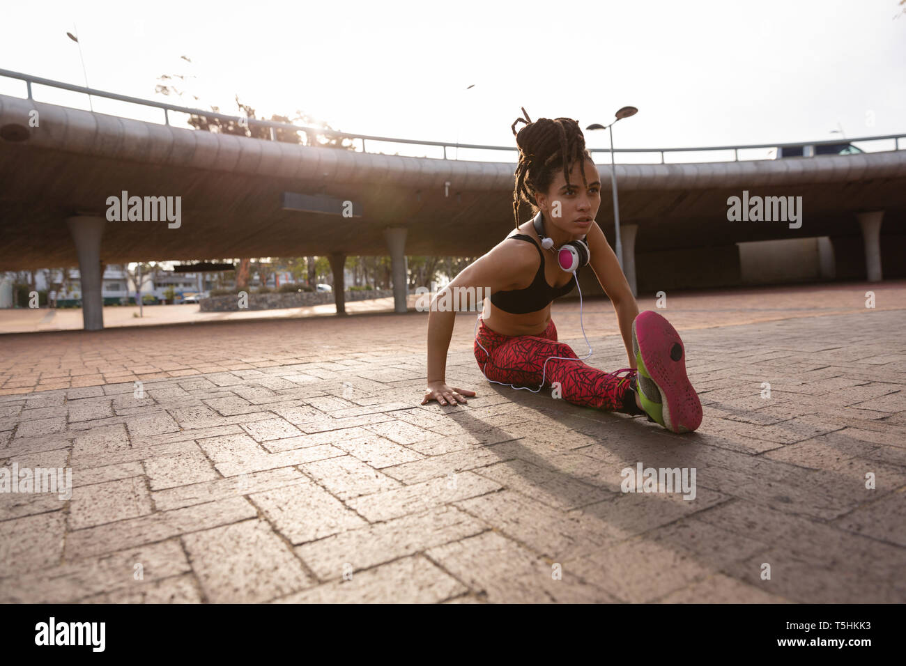 Young woman doing stretching exercice dans la rue Banque D'Images Young woman doing stretching exercice dans la rue Banque D'Images