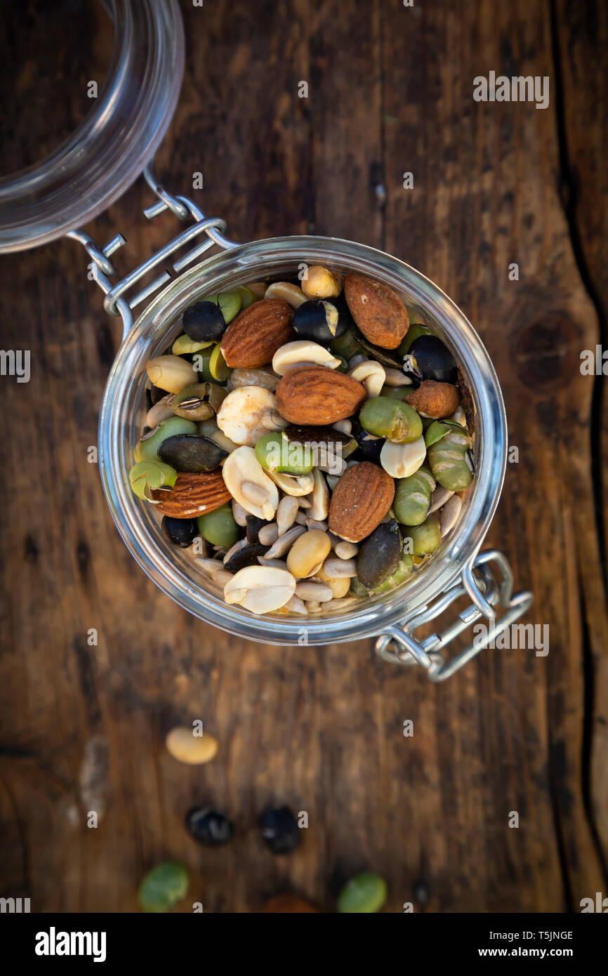 Bocal de haricots de soja rôties, les graines et les noix sur bois Banque D'Images