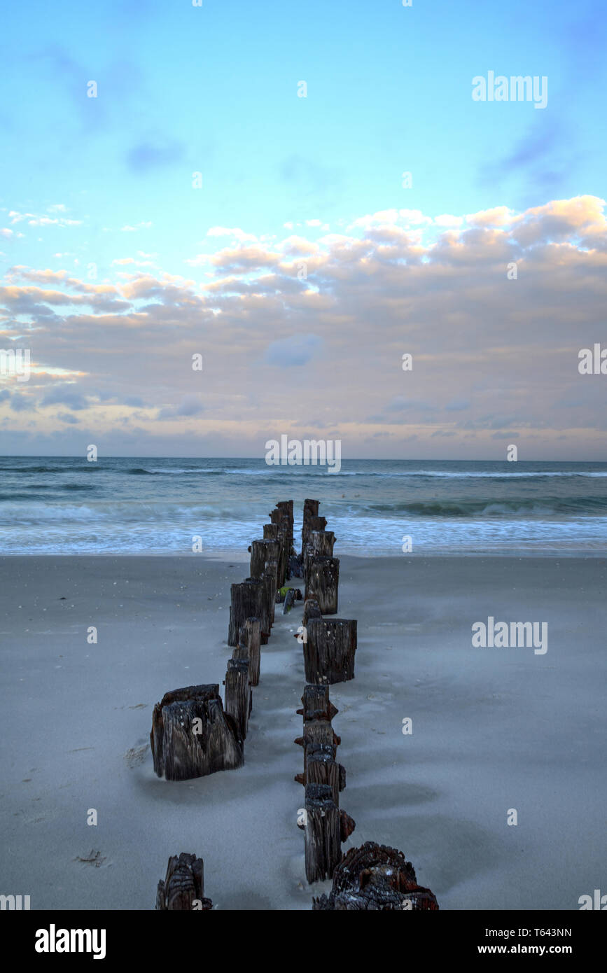 L'aube sur une jetée en ruine sur la plage de Port Royal de Naples, en Floride. Banque D'Images