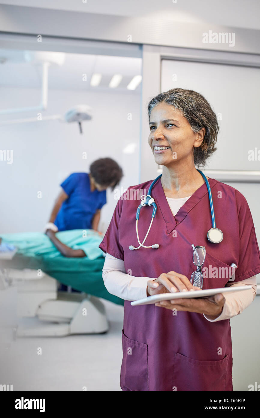 Confiant, female doctor with digital tablet in clinic Banque D'Images