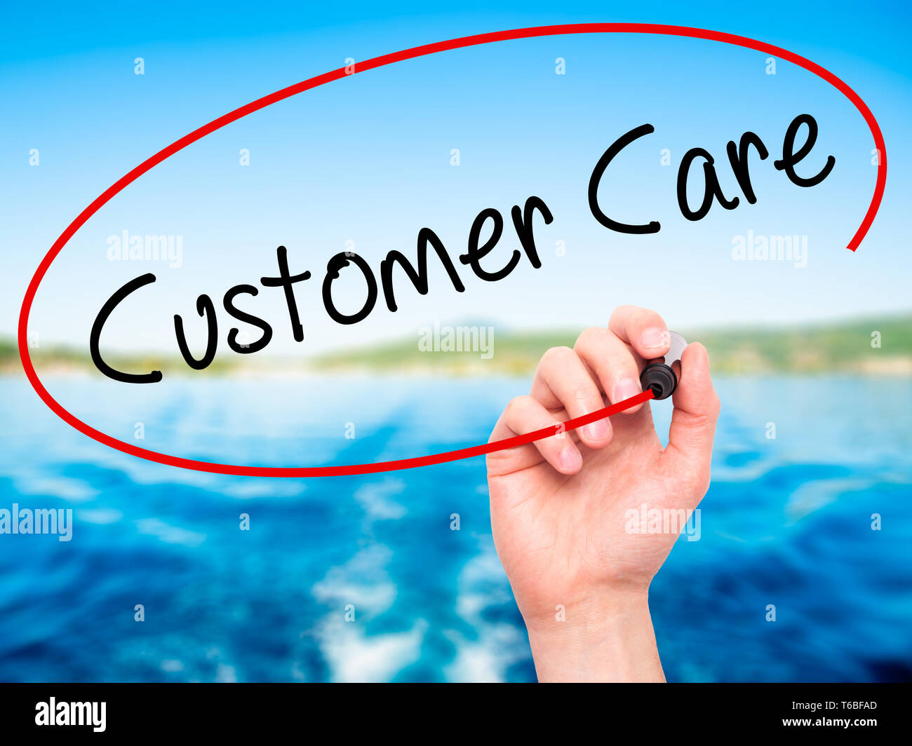 Man main écrit Customer Care avec marqueur noir sur l'écran visuel Banque D'Images