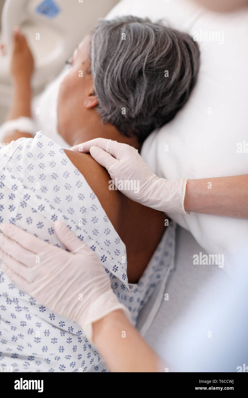 Contrôle le fournisseur de peau du patient à l'arrière Banque D'Images