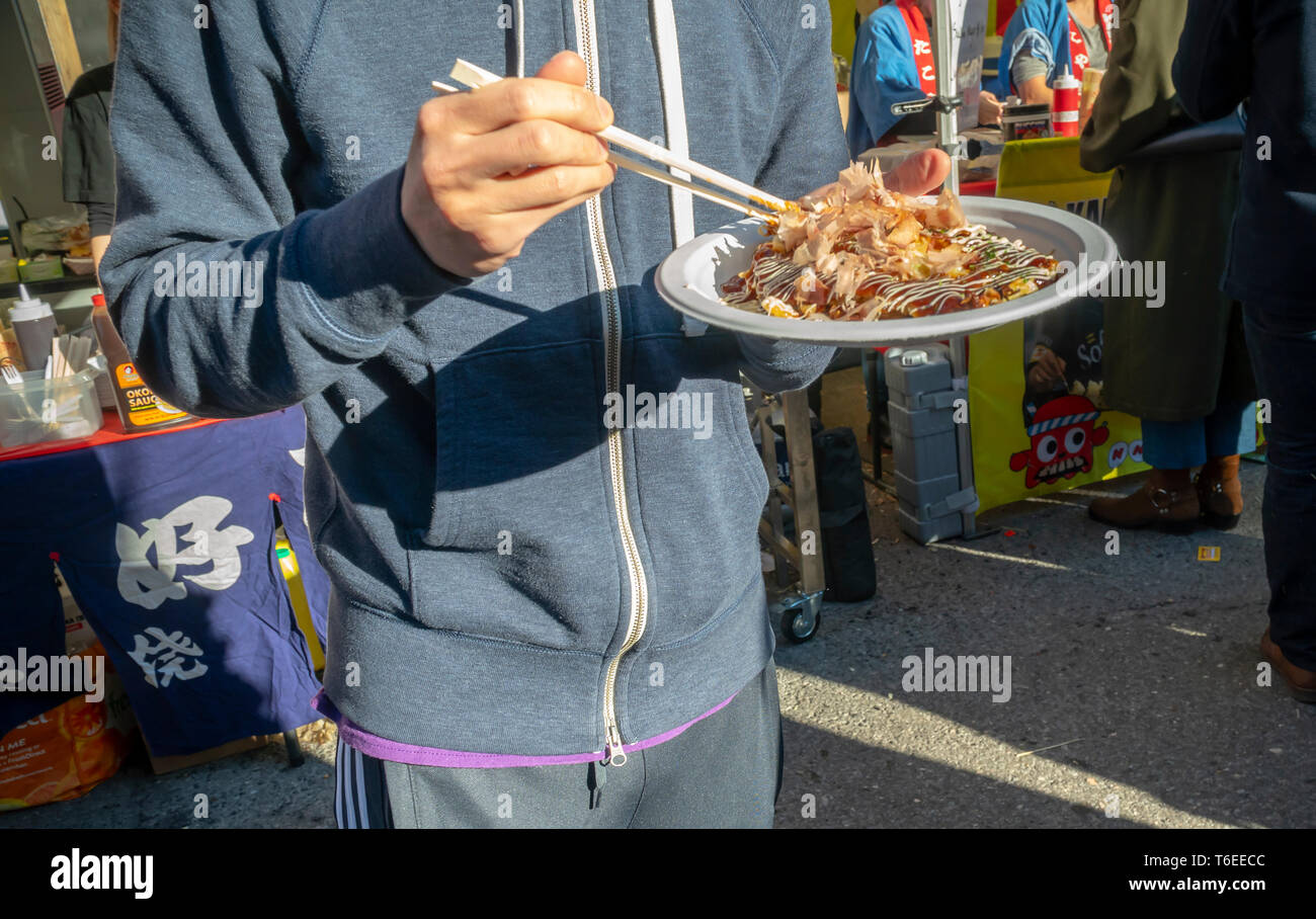 Les amateurs de profiter d'aliments de rue japonais lors d'une foire de rue dans le quartier de Chelsea, New York sur une chaude Samedi 27 Avril, 2019. (© Richard B. Levine) Banque D'Images