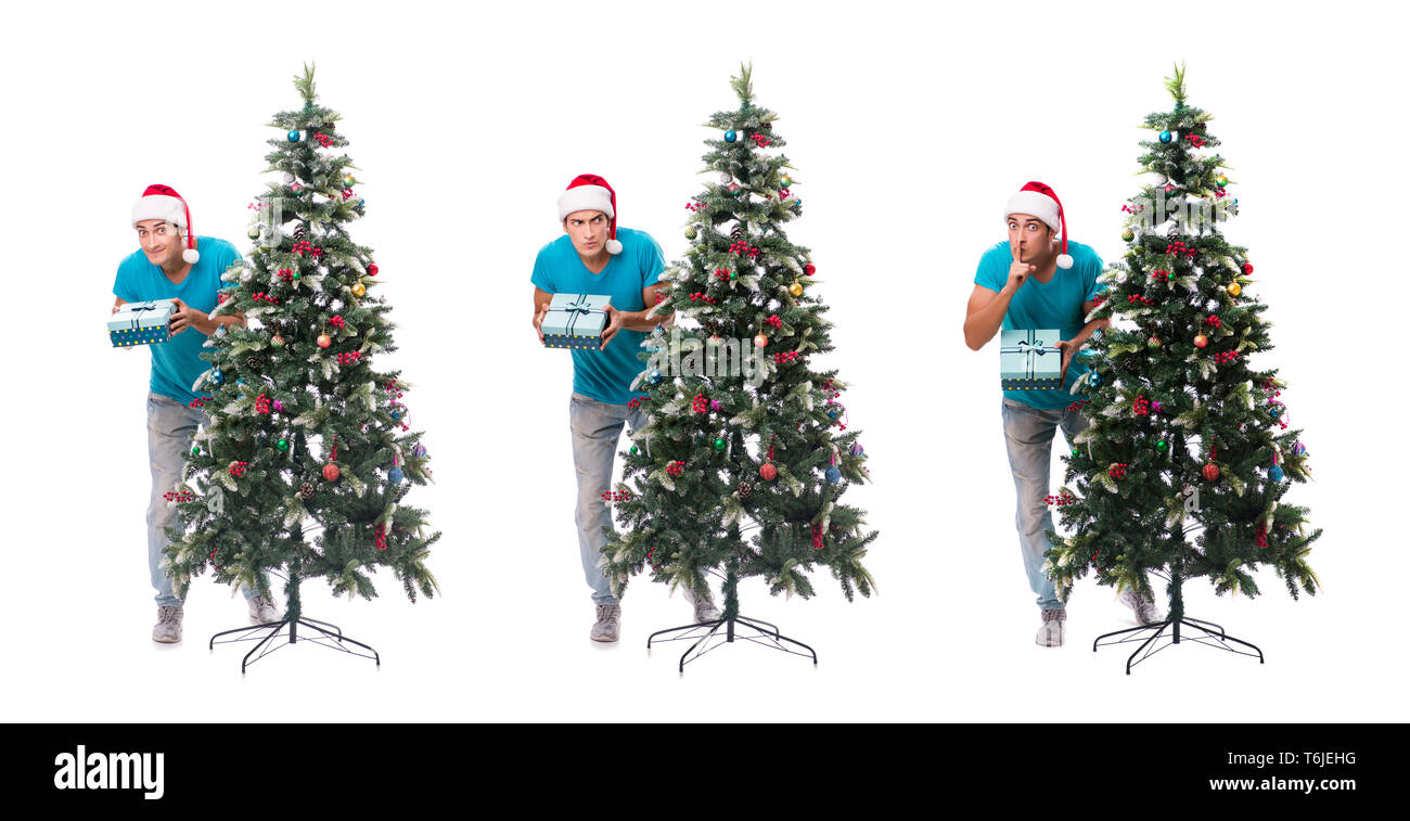 Jeune homme decorating Christmas Tree isolated on white Banque D'Images