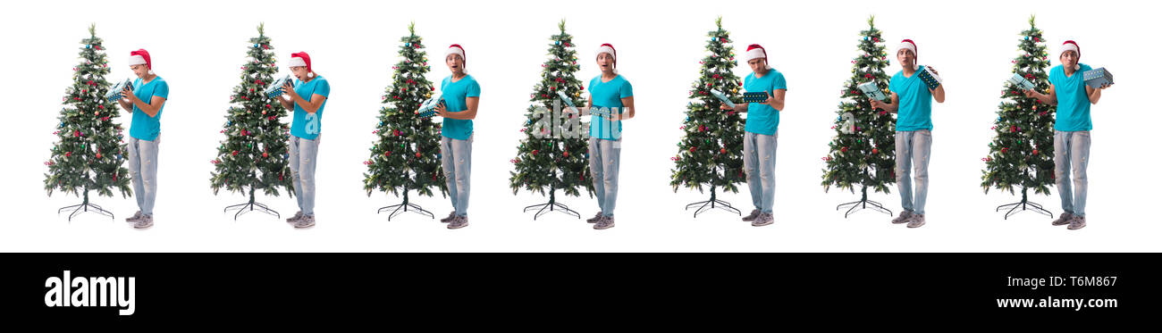 Jeune homme decorating Christmas Tree isolated on white Banque D'Images