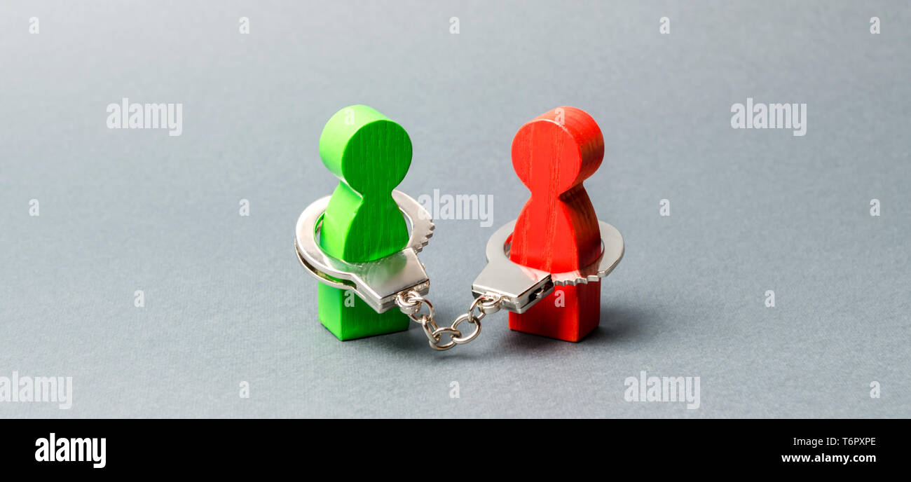 Deux personnes sont menottés. Lien indissoluble. De solides relations de confiance et des partenaires fiables. Affaire concept. Transaction. Soutien. Sol en bois Banque D'Images