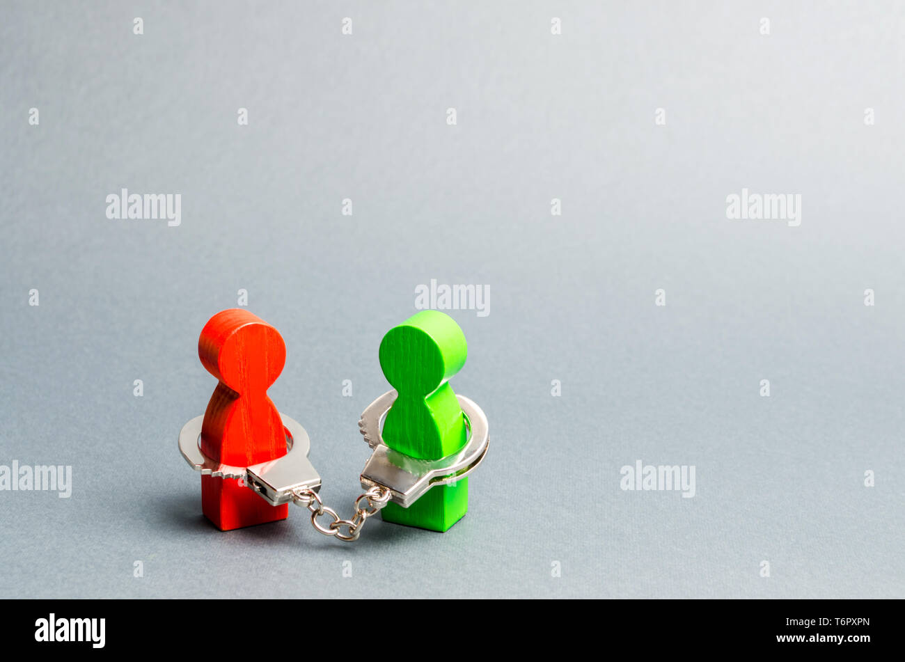 Deux personnes sont menottés. Lien indissoluble. De solides relations de confiance et des partenaires fiables. Affaire concept. Transaction. Soutien. Sol en bois Banque D'Images