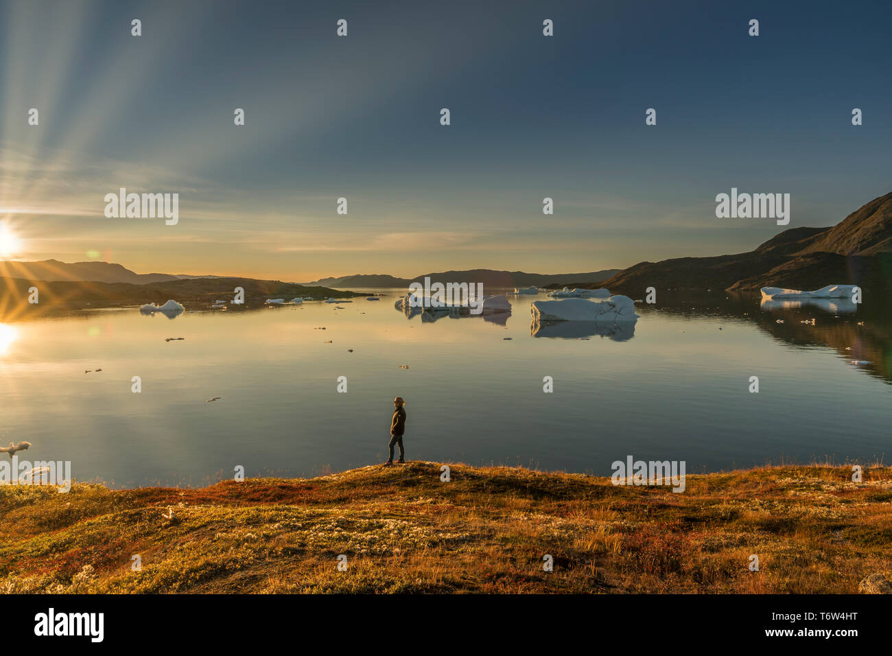 Femme au coucher du soleil, Narsaq, fjord Tunulliarfik, Sud du Groenland Banque D'Images