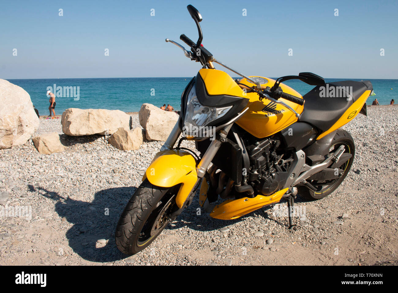 Moto Honda jaune garé sur la plage à Antibes France Photo Stock - Alamy