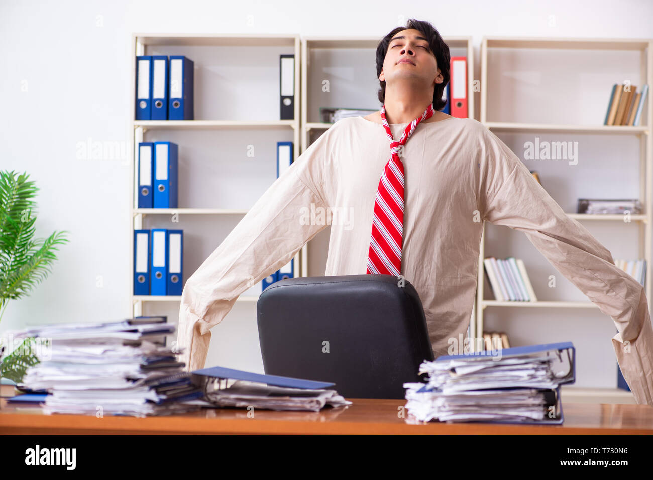 Jeune homme fou en camisole au bureau Banque D'Images