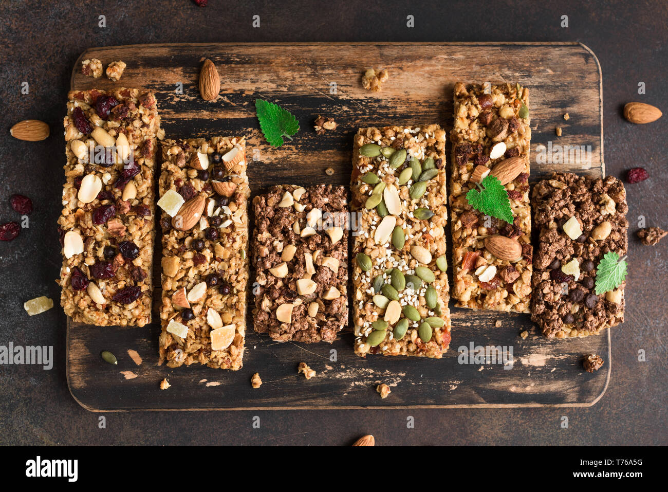 Divers Les barres granola sur fond rustique foncé, vue du dessus. Collation santé faits maison - granola superfood bars. Banque D'Images