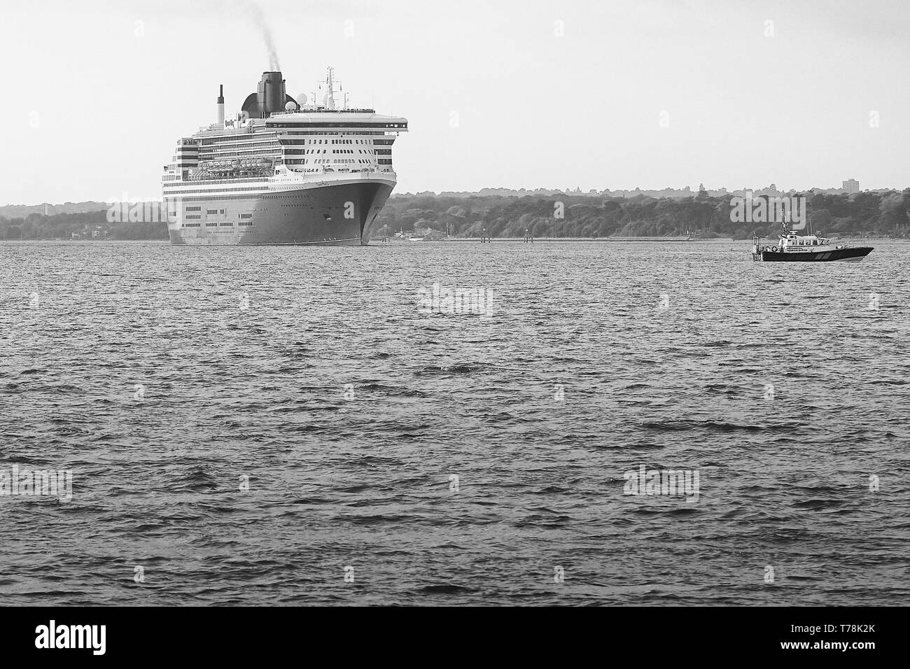 Photo en noir et blanc du navire amiral de la Cunard Line, RMS QUEEN MARY 2, sortant de Southampton Water, à destination de New York, États-Unis Banque D'Images