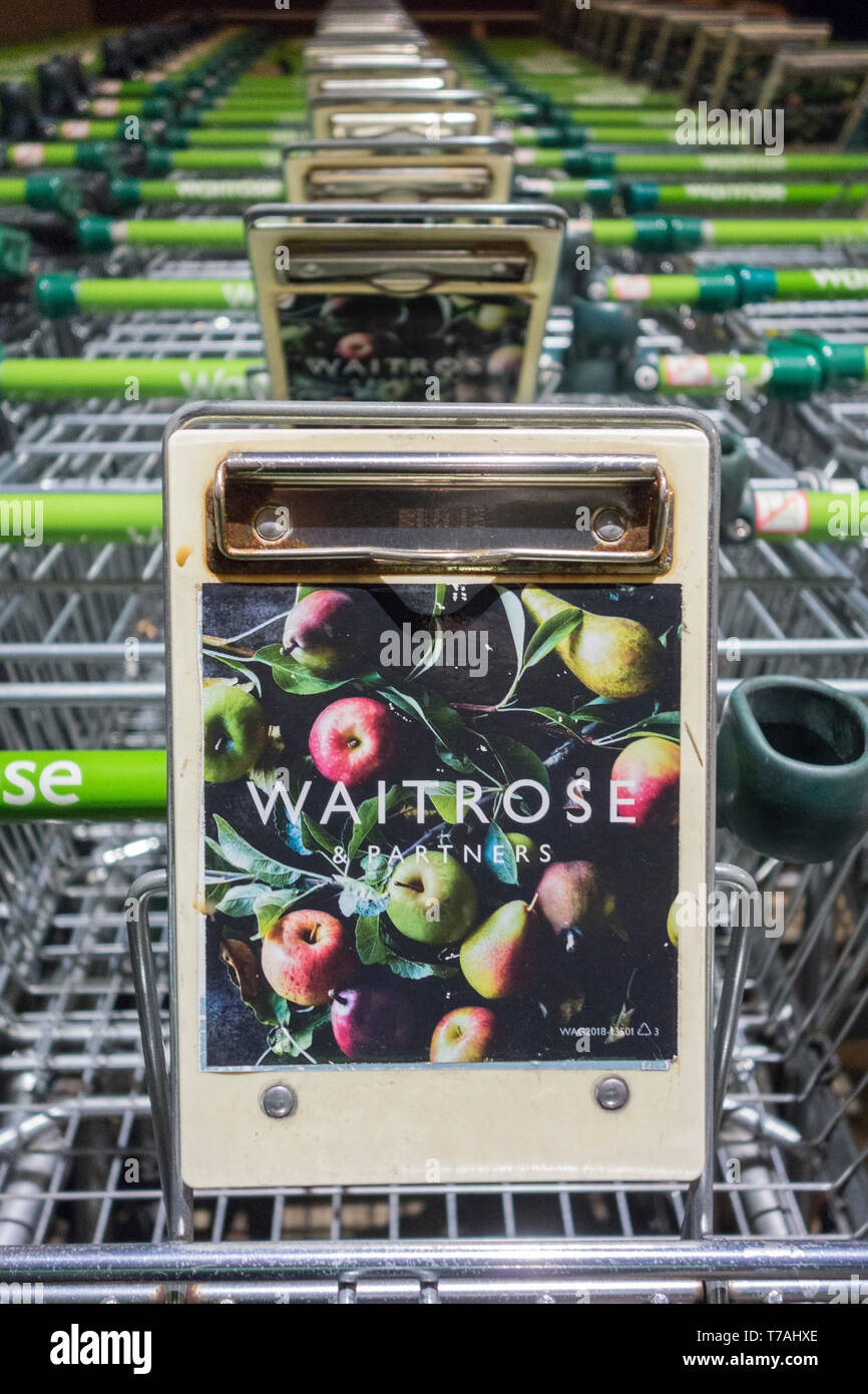 Une rangée de chariots Waitrose Shopping empilés sans cage garés à l'extérieur d'un magasin London Waitrose Banque D'Images