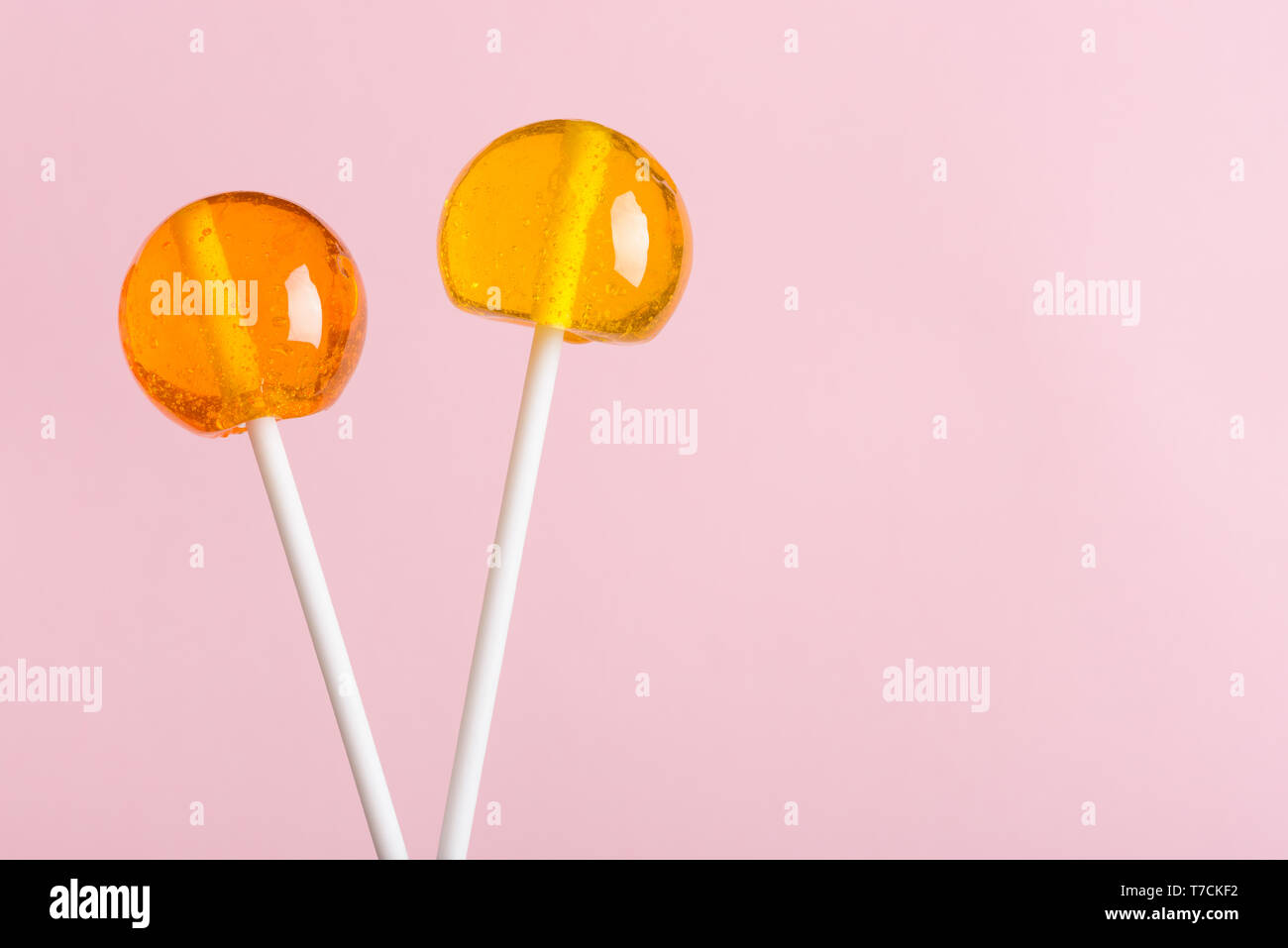 Lollipops sur bâtonnets en plastique blanc sur fond pastel rose with copy space Banque D'Images