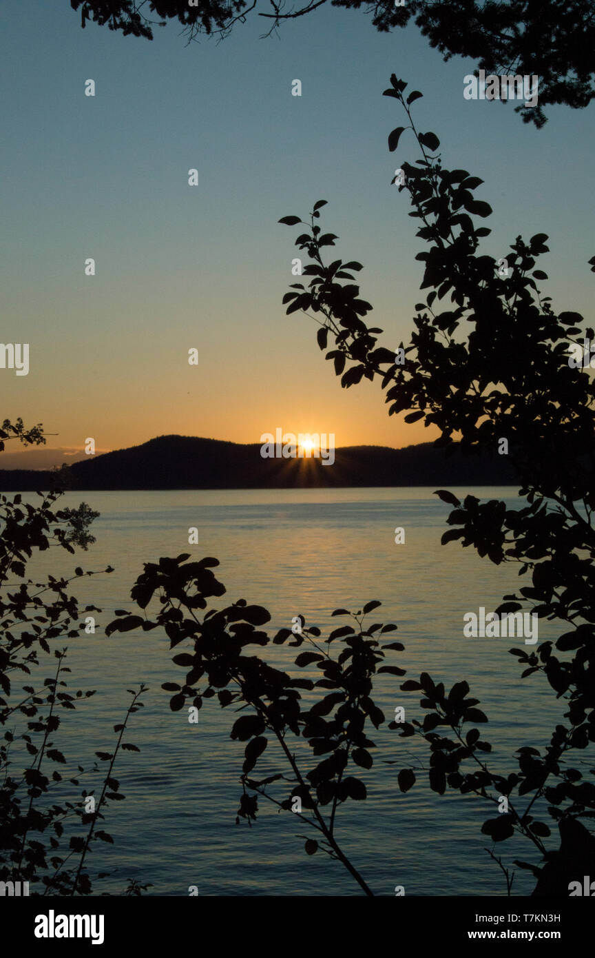 Vue sur le coucher du soleil depuis l'extrémité ouest de l'île Fidalgo, dans les îles San Juan de l'État de Washington. Banque D'Images