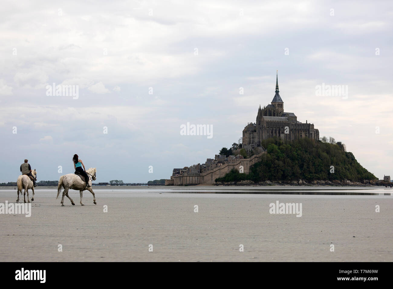 Traversée de la baie sur le sable du Mont Saint Michel sur les chevaux, Normandie, France Banque D'Images