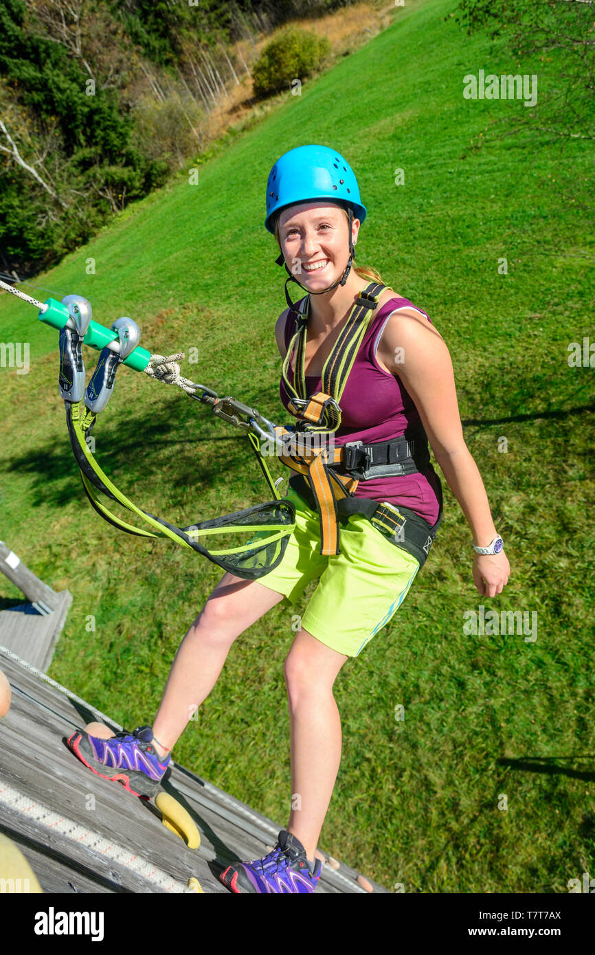 Femme intrépide pendant la descente en rappel formation au mur d'escalade Banque D'Images