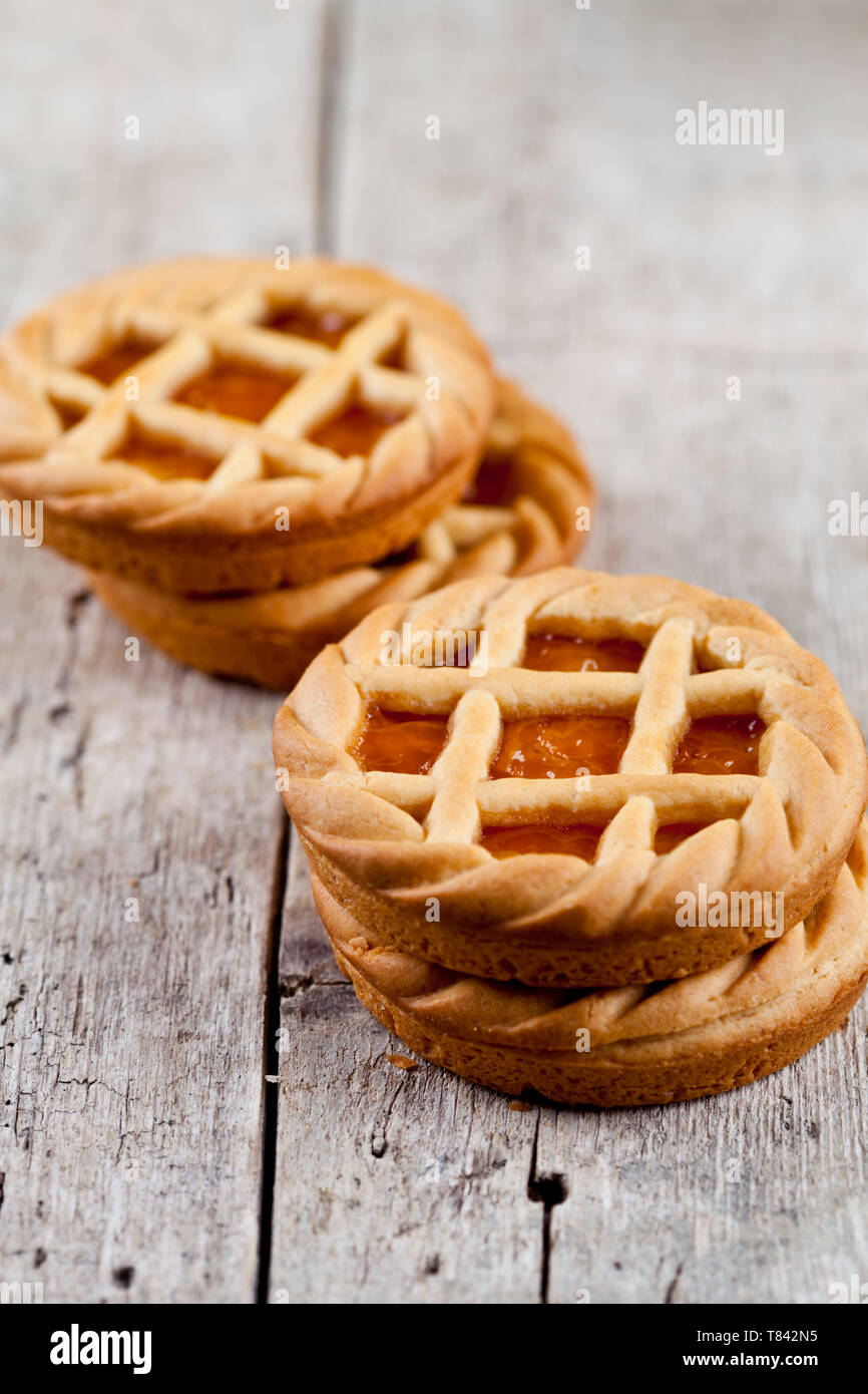 Tartes fraîchement cuit au four avec de la marmelade ou confiture d'abricot sur le fond de la table en bois rustique. Banque D'Images