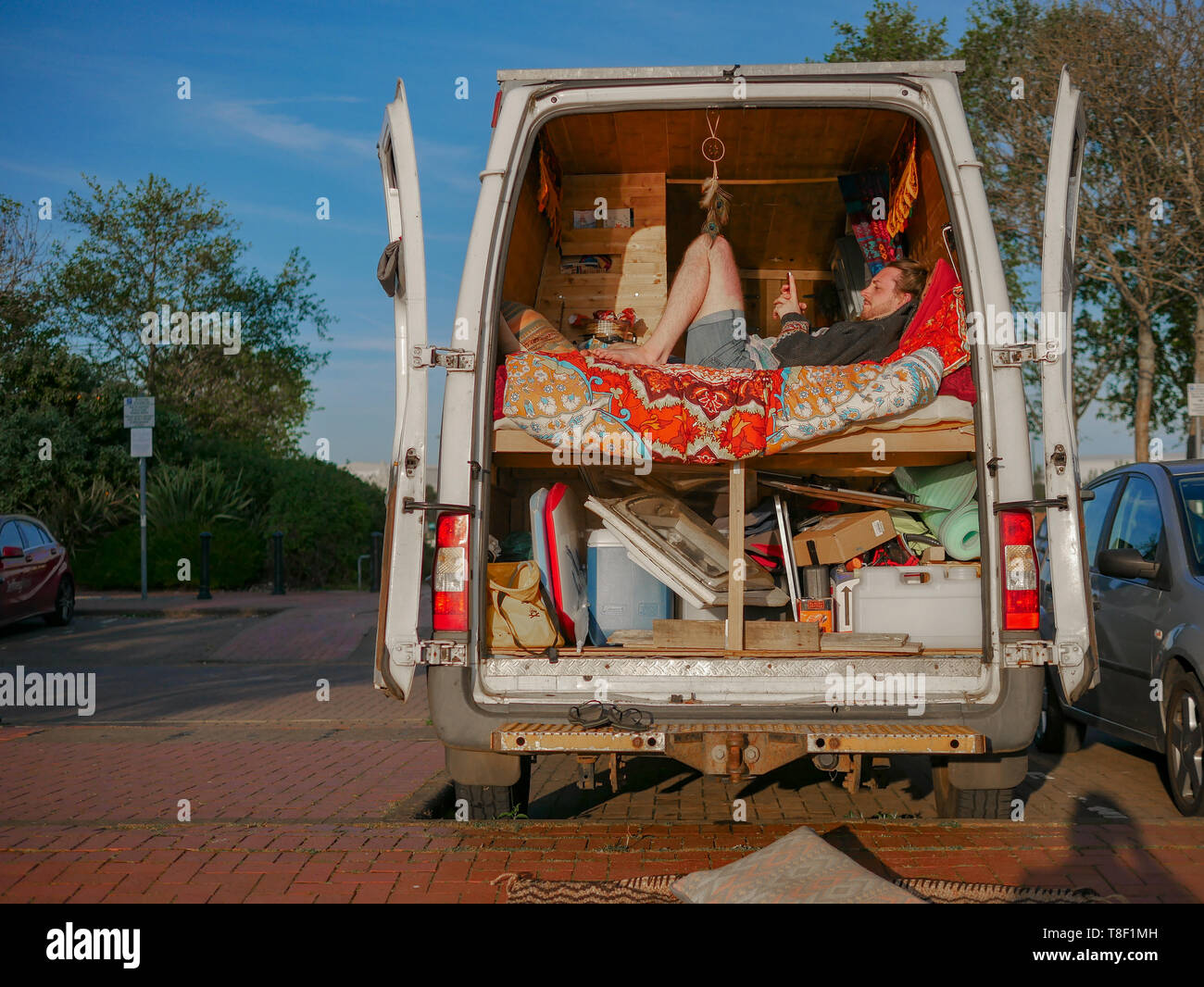 D'autres vivant dans la ville - un homme est assis dans sa converti accueil van dans le centre de Cardiff Bay Banque D'Images