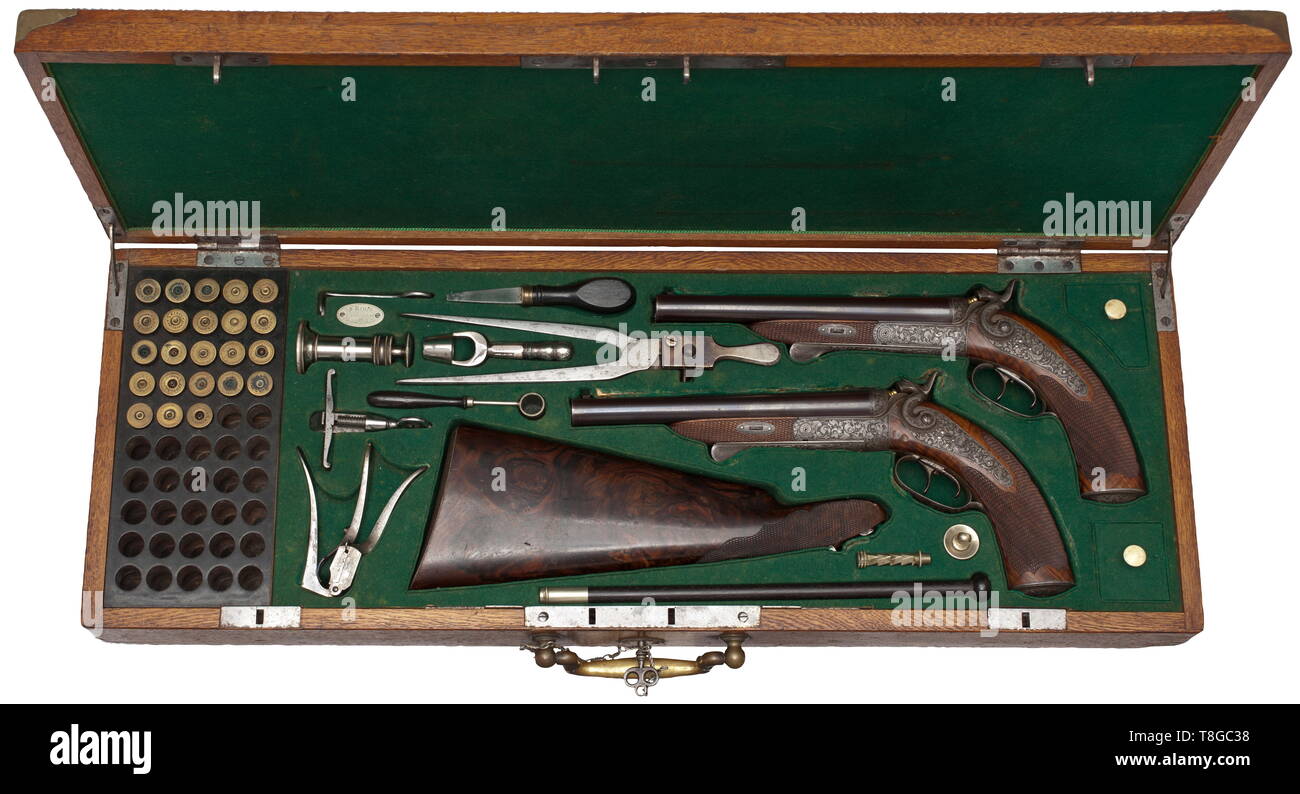 Une paire de pistolets d'un marteau à double branche, dans leur cas, Ferdinand Reuss à Mehlis vers 1880/90. Lumineux, canons rayés à 16,8 mm. Barils bruni et usiné nervure avec deux sites arrière rabattable chacun. Sur la face supérieure des deux barils de l'or incrusté signature et marqué 'BESTELLT C. NICOLAS DE HARDINN'. T-lock, double ensemble de triggers. Des marteaux, des platines, montage avec gravé, gravure profonde, une vigne. Attaquer avec quadrillage fin. Vient avec stock amovible faites de grains de bois finement la racine d'une salle de montage en fer gravé. Additional-Rights Clearance-Info-Pist,-Not-Available Banque D'Images