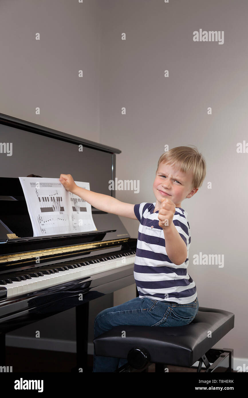 Garçon, 4 ans, ne veut pas jouer du piano. Banque D'Images