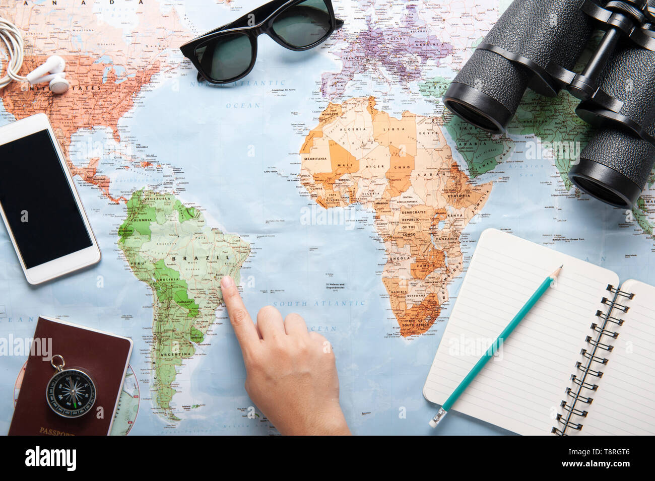 Vue de dessus de la carte du monde, des lunettes, des jumelles et de  passeport avec textos l'espace, voyager concept, planifier un voyage,  carnet de voyage, une part à point e Photo