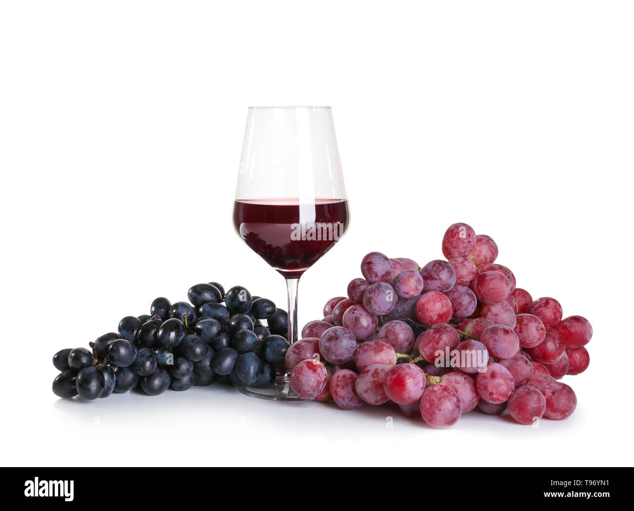 Verre de vin rouge avec des raisins mûrs sur fond blanc Banque D'Images