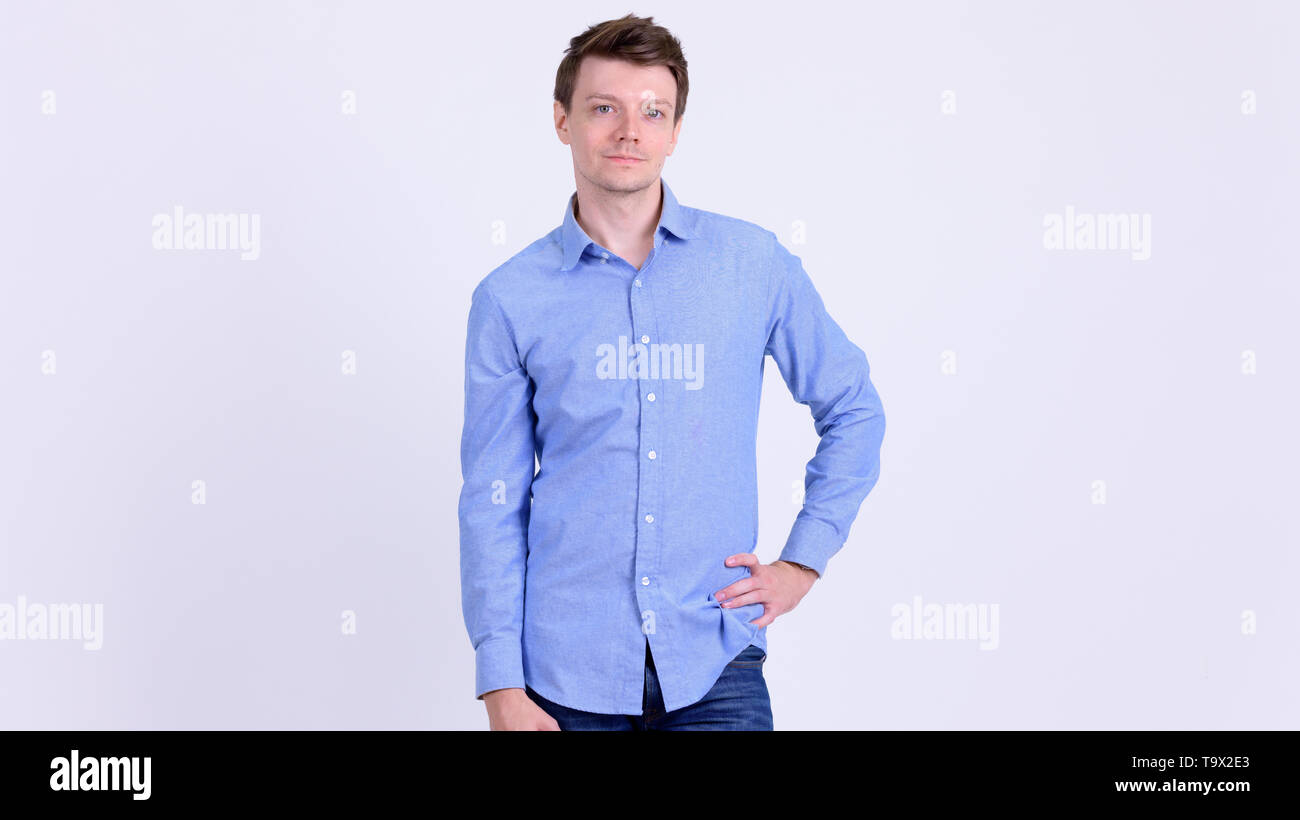 Portrait of young handsome businessman with hand on hip Banque D'Images