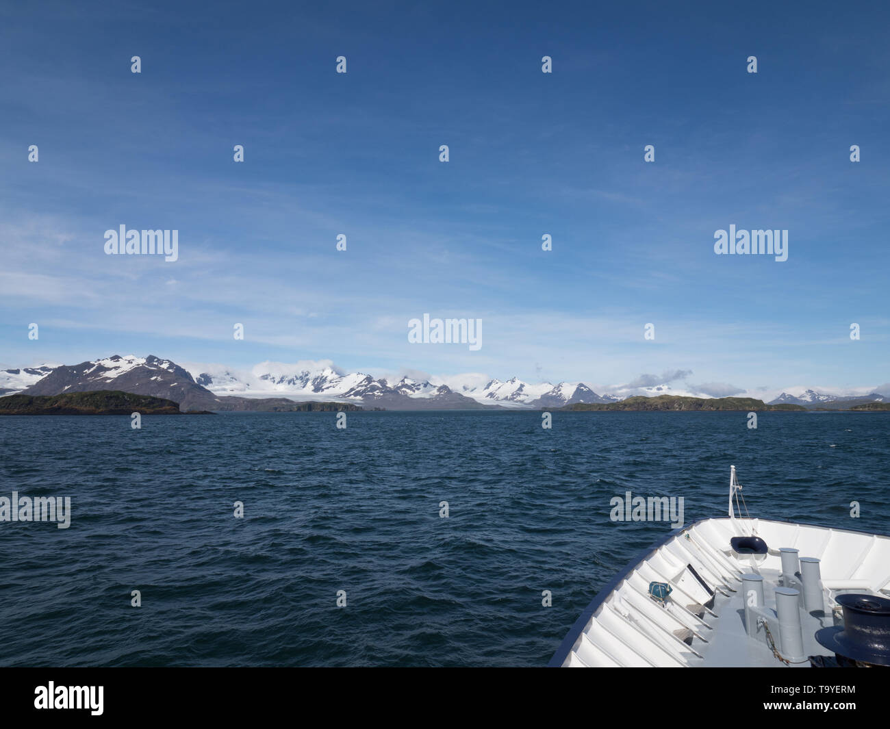 Vue d'une montagne sur une des îles de Géorgie du Sud et de l'étrave et pont d'un navire de croisière ci-dessus. Banque D'Images