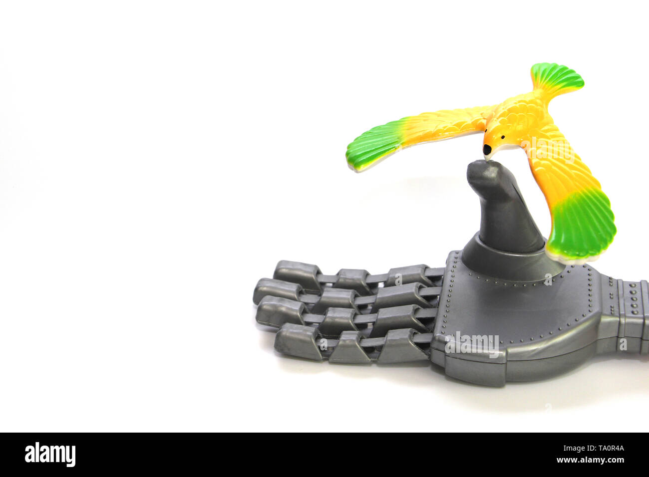 Un petit oiseau est assis sur le doigt d'un robot. L'oiseau est jaune, il n'est pas vivant. La main du robot est un jouet. Le concept de l'amour et la bonté. Banque D'Images