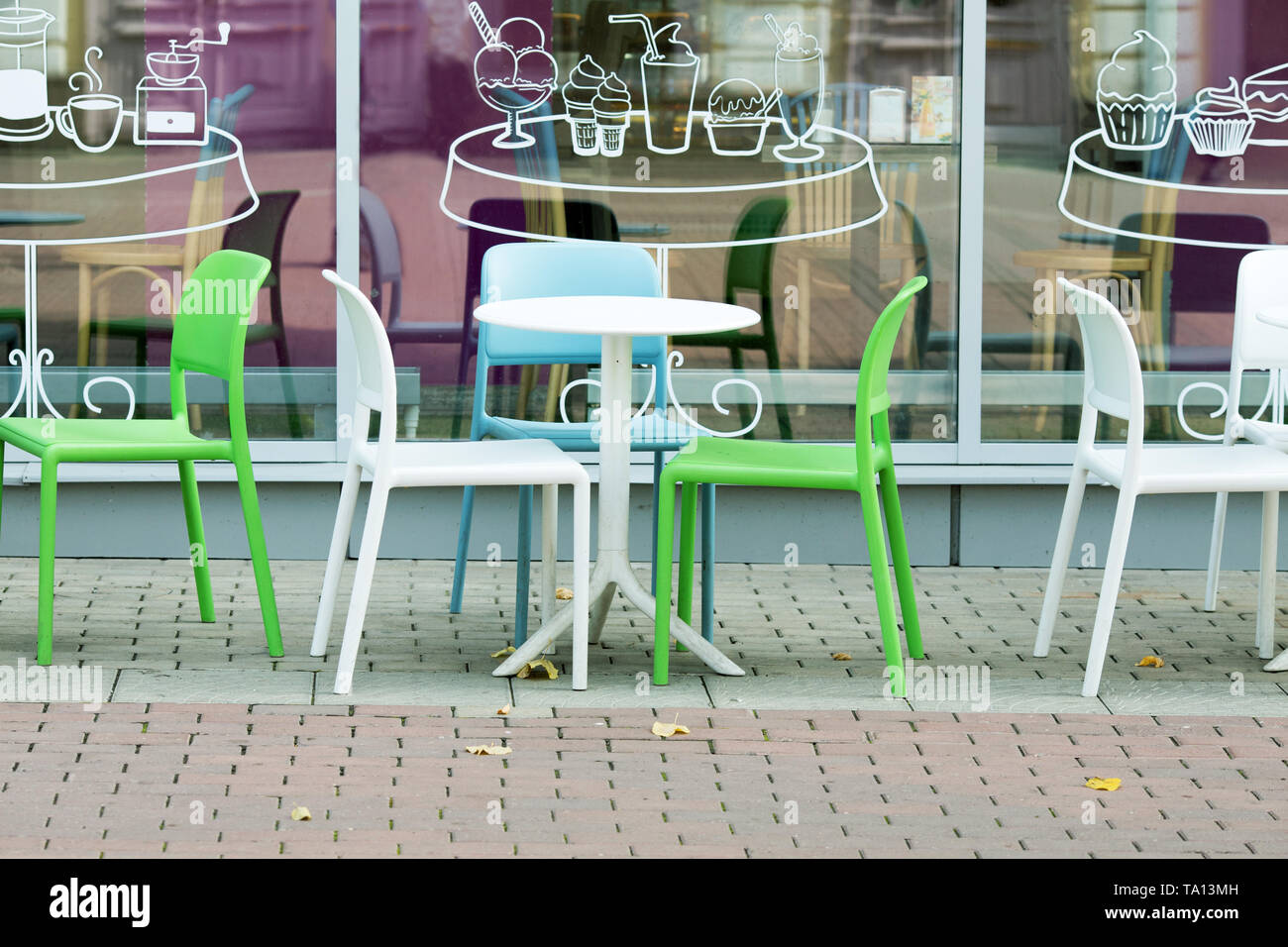 En plastique blanc et vert des tables et des chaises d'un café de la rue Banque D'Images