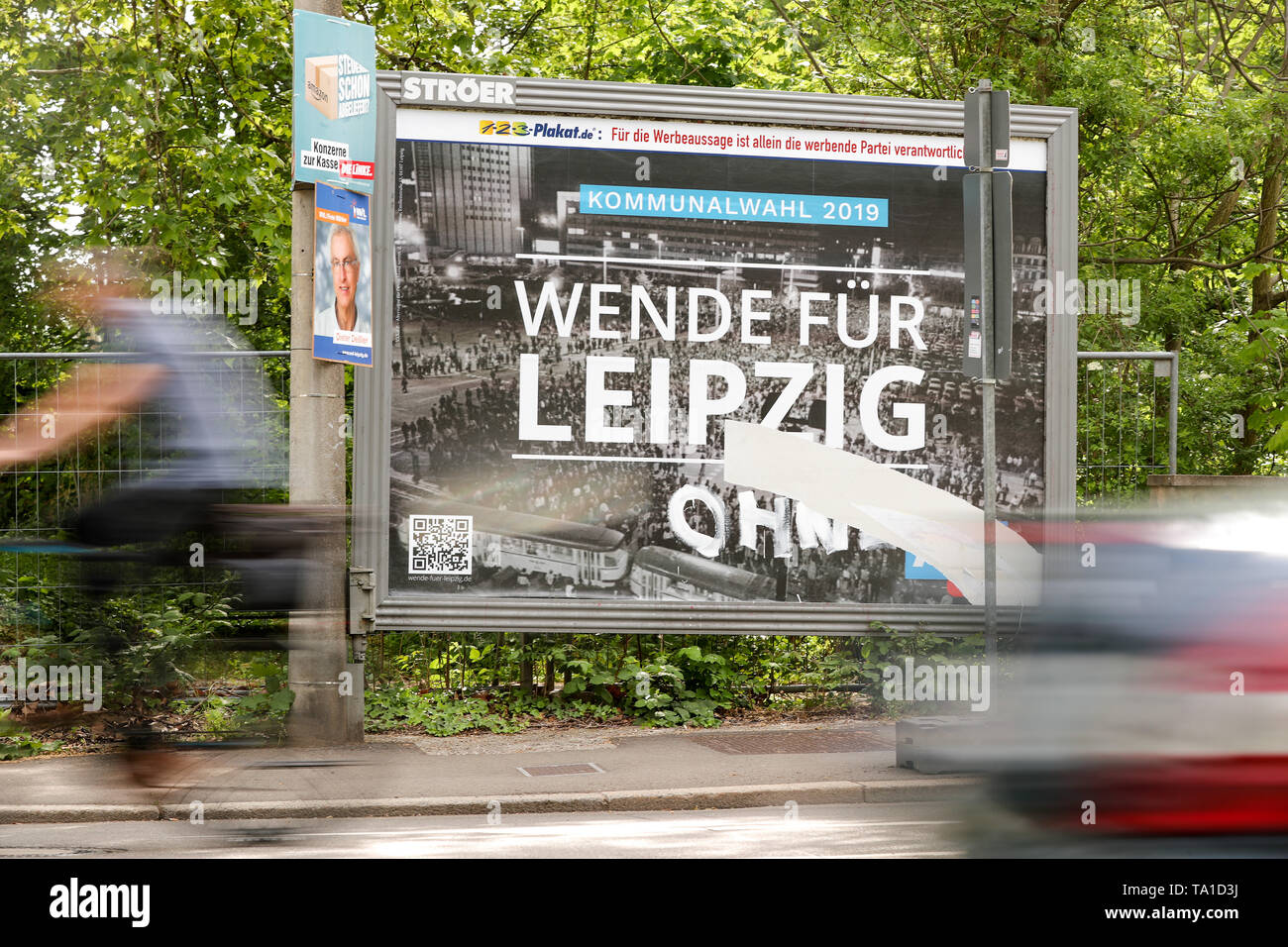 21 mai 2019, Leipzig, Saxe : passants de passer devant une affiche électorale de l'AfD avec une photo de la chute du communisme en 1989. La famille d'un ancien photographe de l'agence critique l'utilisation de la photo sur une affiche électorale de l'AfD. La photo en noir et blanc montre une manifestation à Leipzig au moment de la chute du mur. Le slogan "l'AfD Wende für Leipzig" (tourner pour Leipzig) est que sur elle pour les élections locales. Elle a été prise par Friedrich Gahlbeck, un photographe de l'agence de presse de la RDA l'ADN décédé entre-temps. Cependant, la famille ne détient pas les droits à l'image Banque D'Images