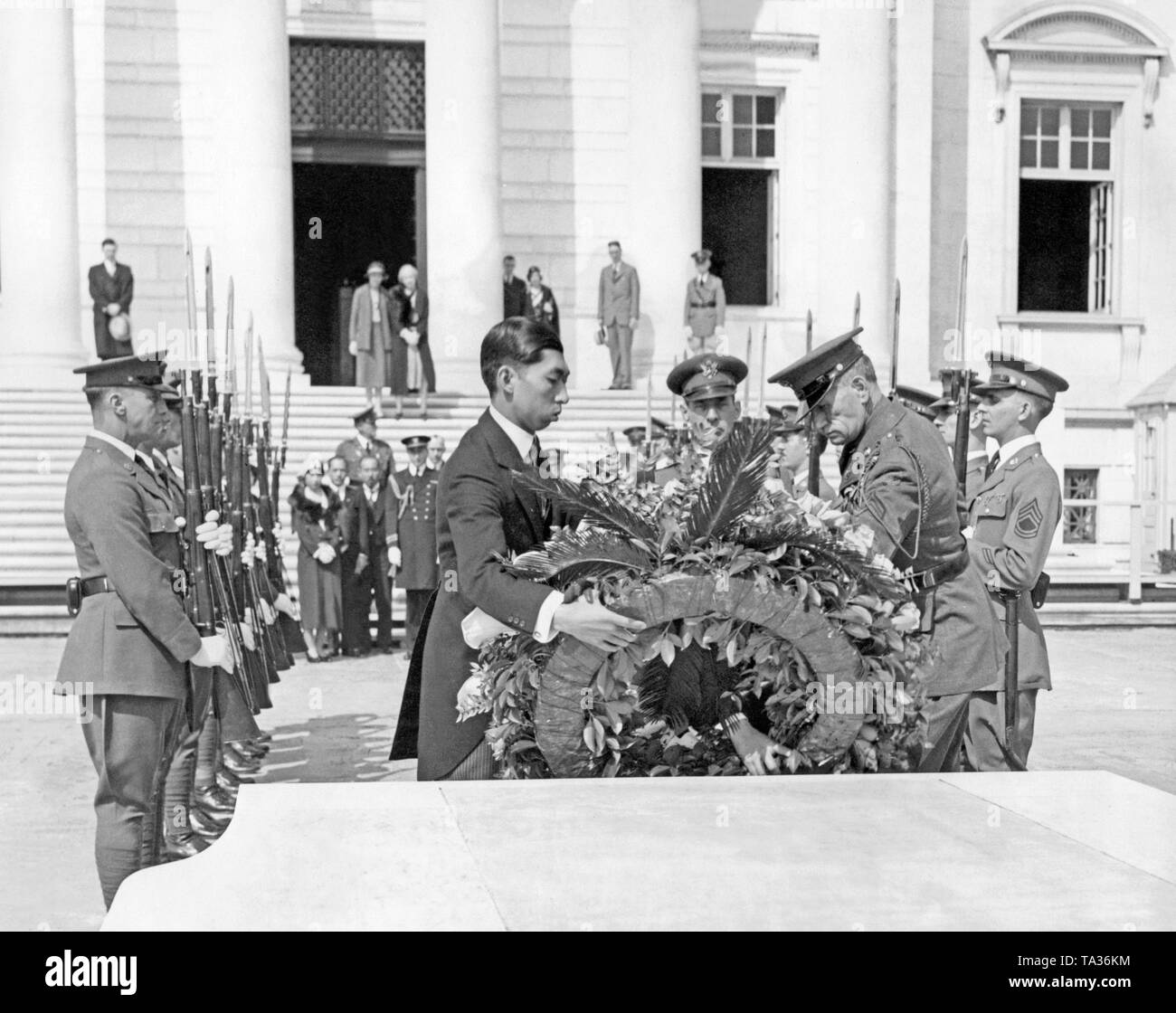 Le Prince japonais (à gauche) pose une couronne sur la Tombe du Soldat inconnu de la Première Guerre mondiale au cimetière national d'Alrington en Virginie le 16 avril 1931 en collaboration avec le Lieutenant Commander Mutzen (centre) et le général Colloins. Banque D'Images