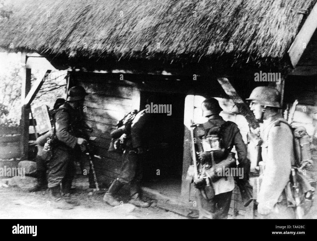 Un détachement d'assaut de la Wehrmacht recherche une maison dans le village de Lazdijai sur la frontière entre la Pologne et la Lituanie. Domaine Groupe d'armées Nord durant les premiers jours de la campagne de l'Est. Gauche sur la photo, un soldat avec radio. Banque D'Images
