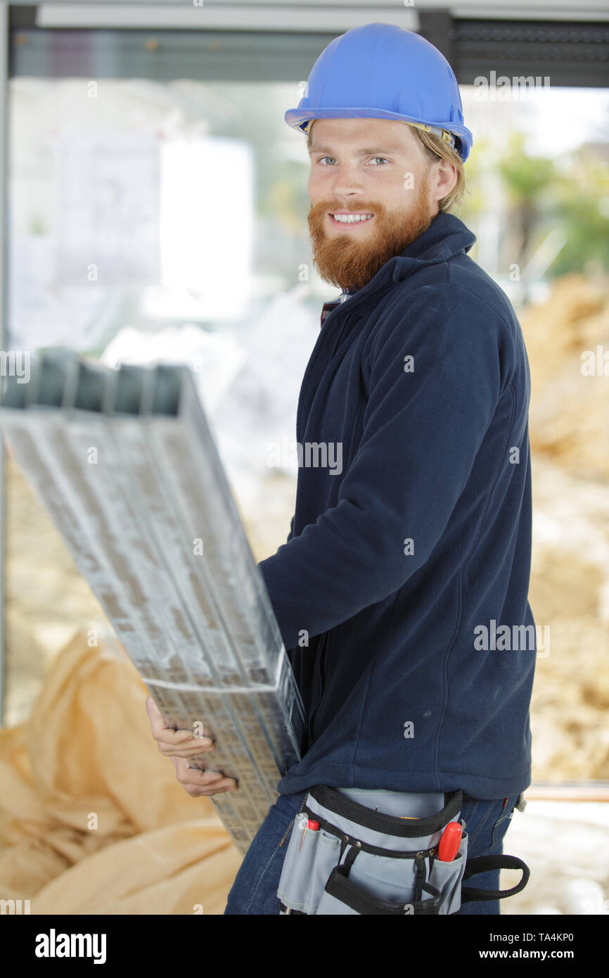 Happy worker carrying load Banque D'Images