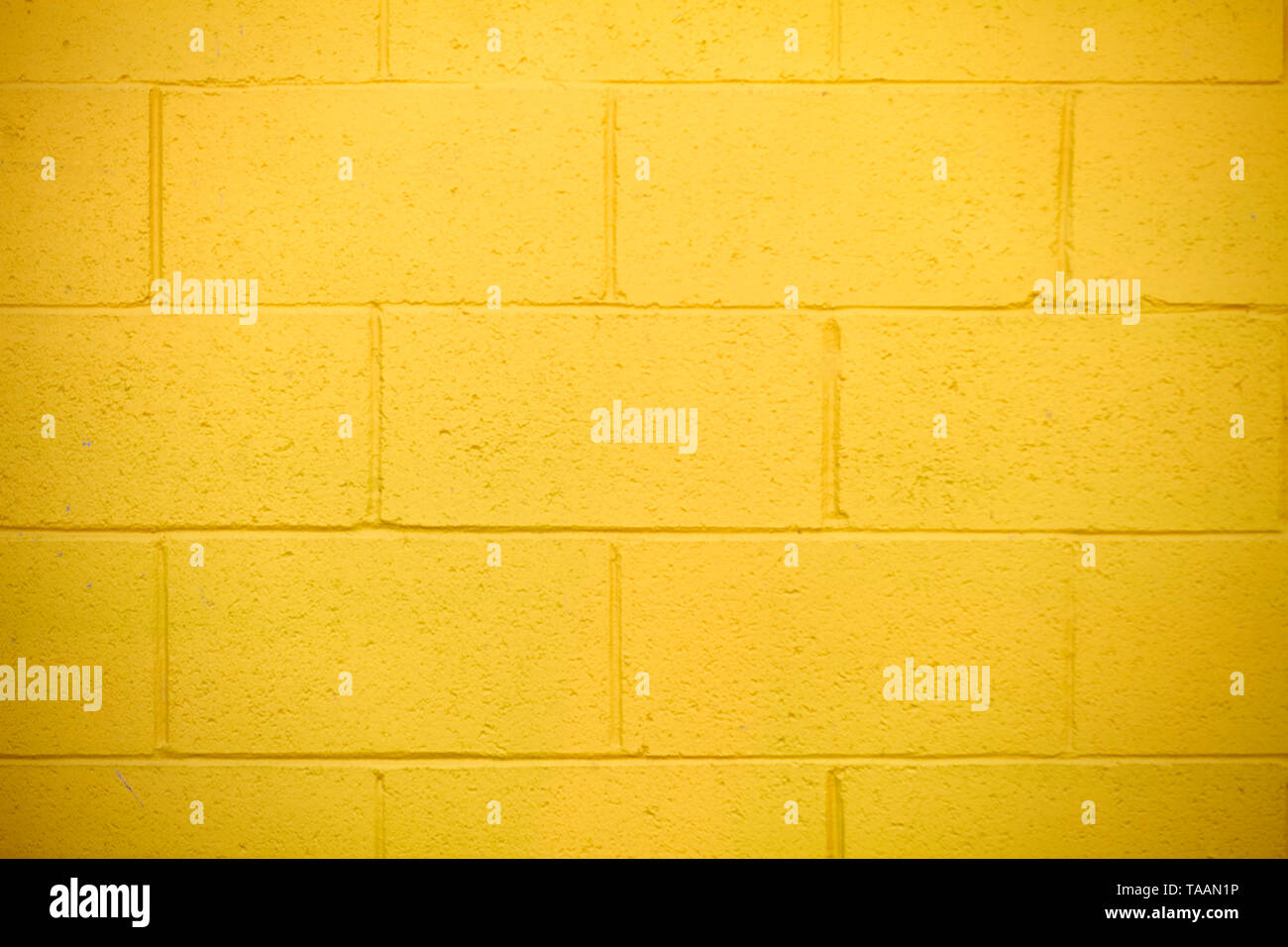 Fond jaune lumineuse brick wall Banque D'Images