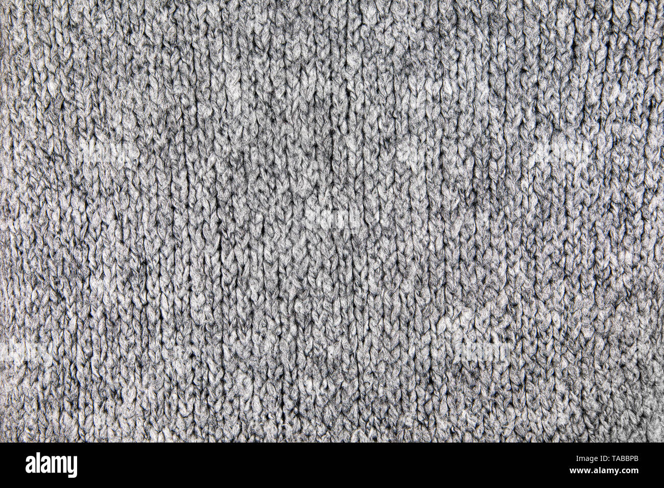 Tissu maille lâche avec la texture de laine. Tricot Machine à répétition de Texture chandail chaud. Fond tricoté gris. Banque D'Images