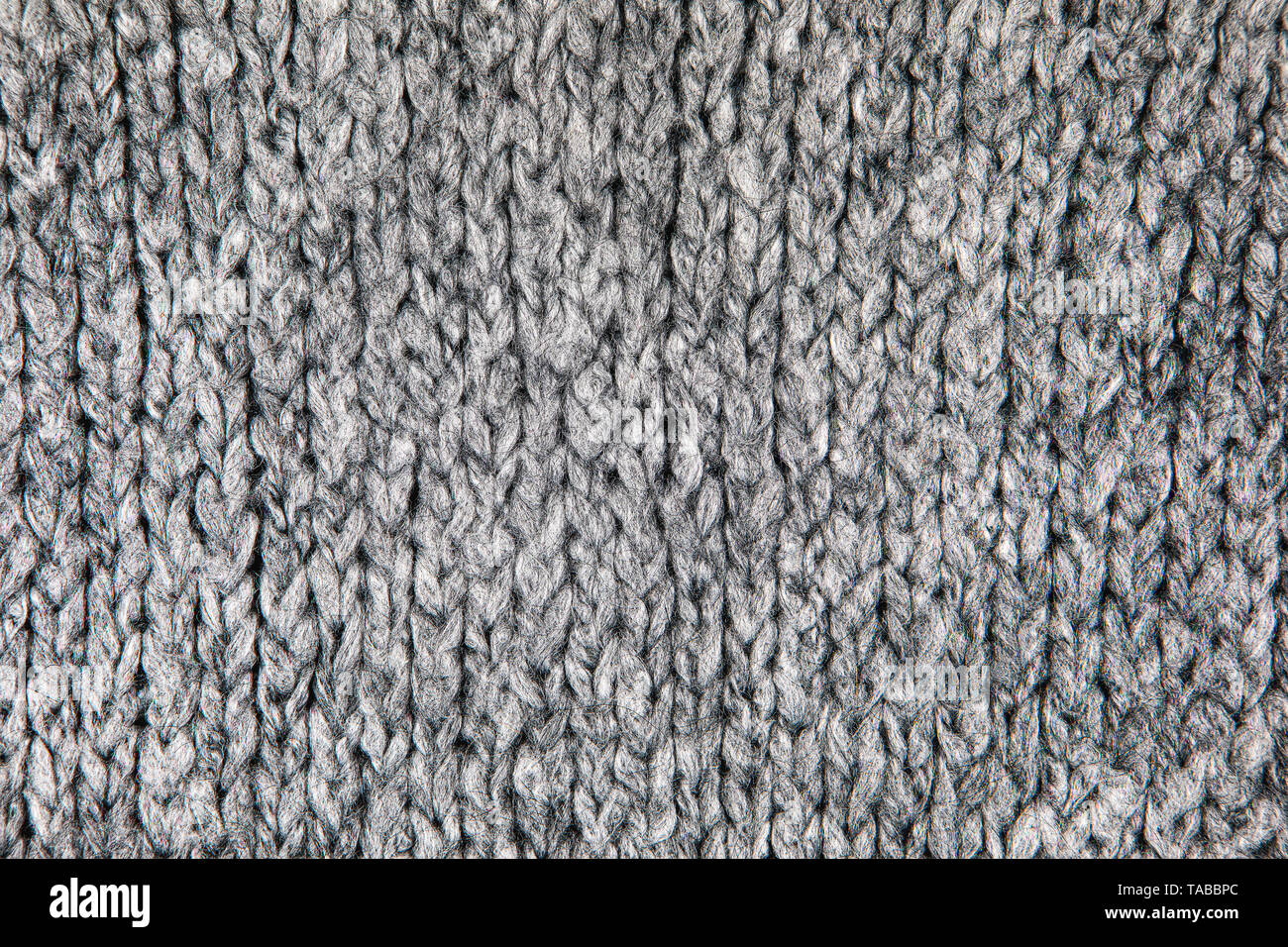 Tissu maille lâche avec la texture de laine. Tricot Machine à répétition de Texture chandail chaud. Fond tricoté gris. Banque D'Images