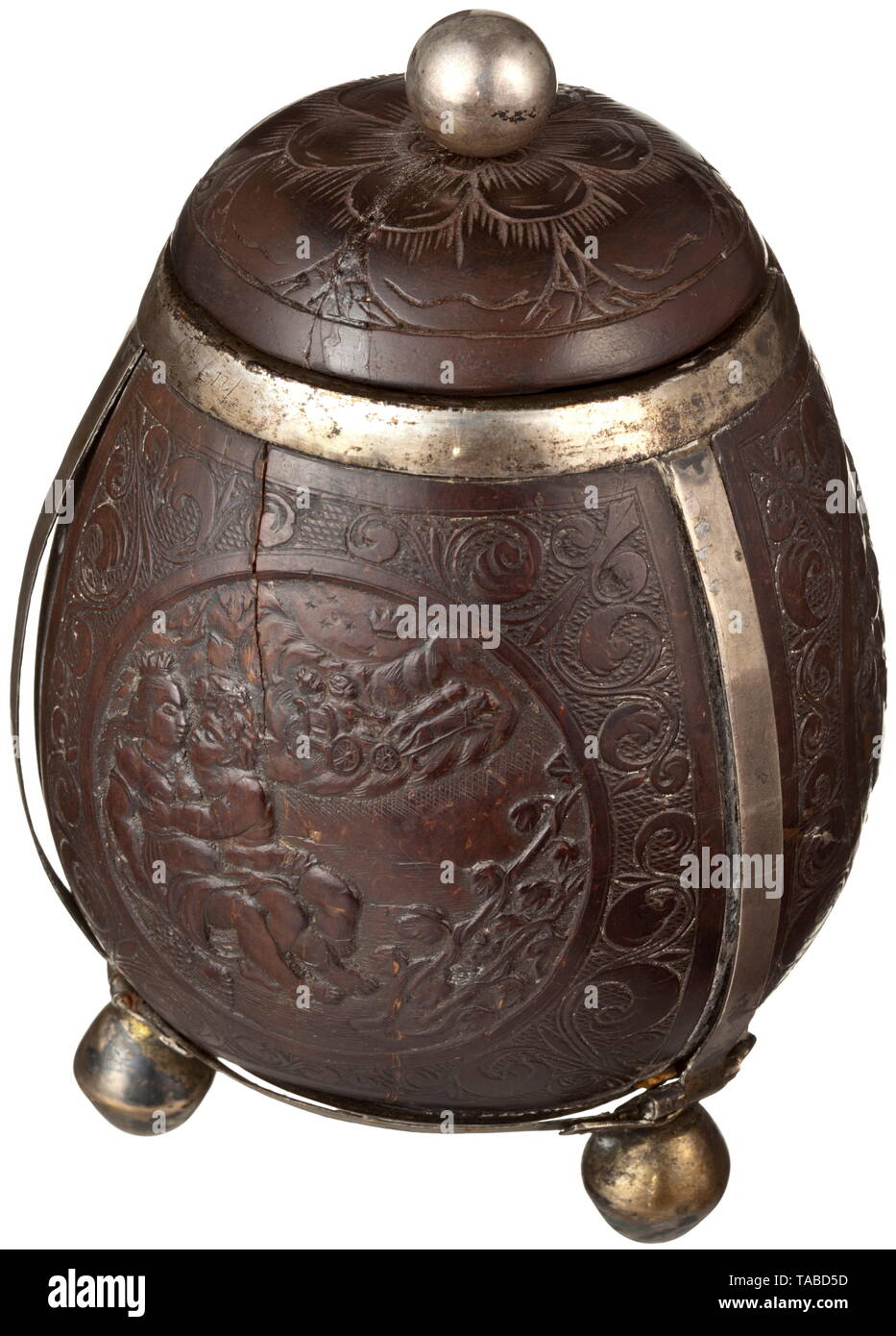 Une boîte de noix de coco ou flamand allemand du 17ème siècle, le corps avec couvercle à capuchon sculpté de noix de coco, de l'argent monté avec trois pieds boule et avec un décor sculpté en relief. Un côté porte un écusson entouré par des vrilles de vigne, tuyaux et accessoires de table. À côté de ce sont deux cartouches, une avec une représentation d'un chérubin que Bacchus à cheval sur un tonneau de vin, l'autre avec angelots amoureux jouer entre vigne vrilles, les cartouches chaque bordée d'un décor de la vrille, la base et le couvercle avec une décoration florale. Le corps porte les petites fissures, l'âge , Additional-Rights Clearance-Info-Not-Available- Banque D'Images